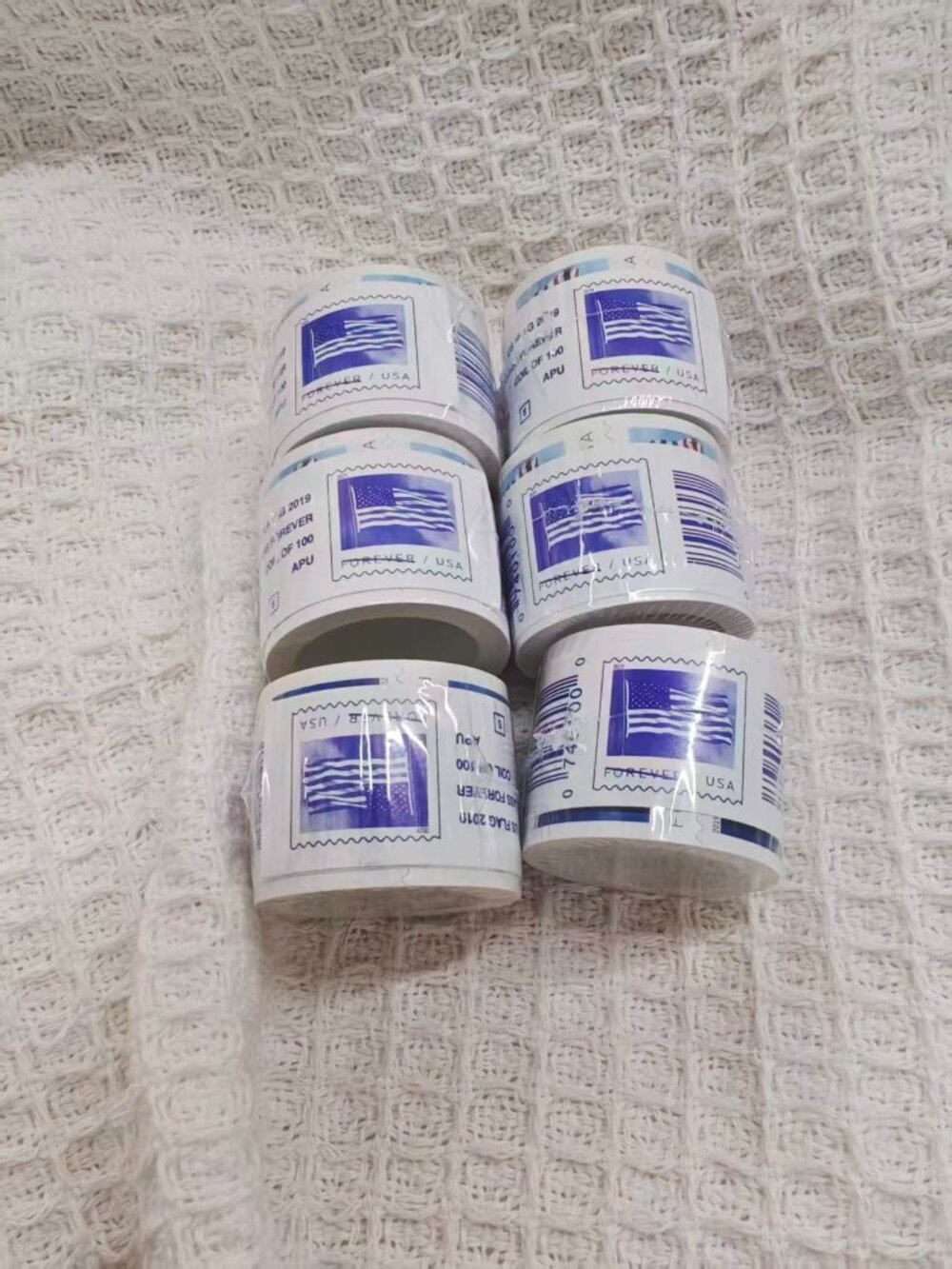 10 rolls of U.S. Postal Service stamps, totaling 1,000 brand new stamps.
